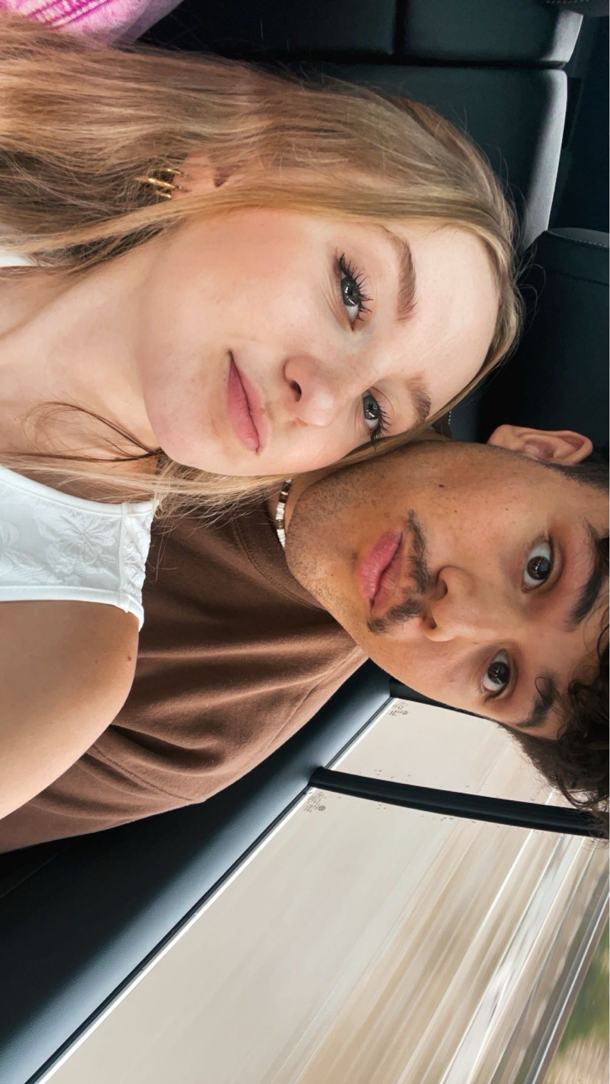 Adrien and Kaylee taking a selfie in the car