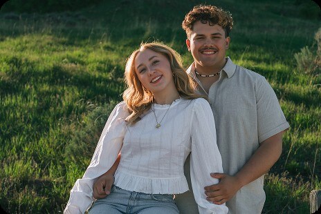 Kaylee and Adrien taking a picture in the mountains